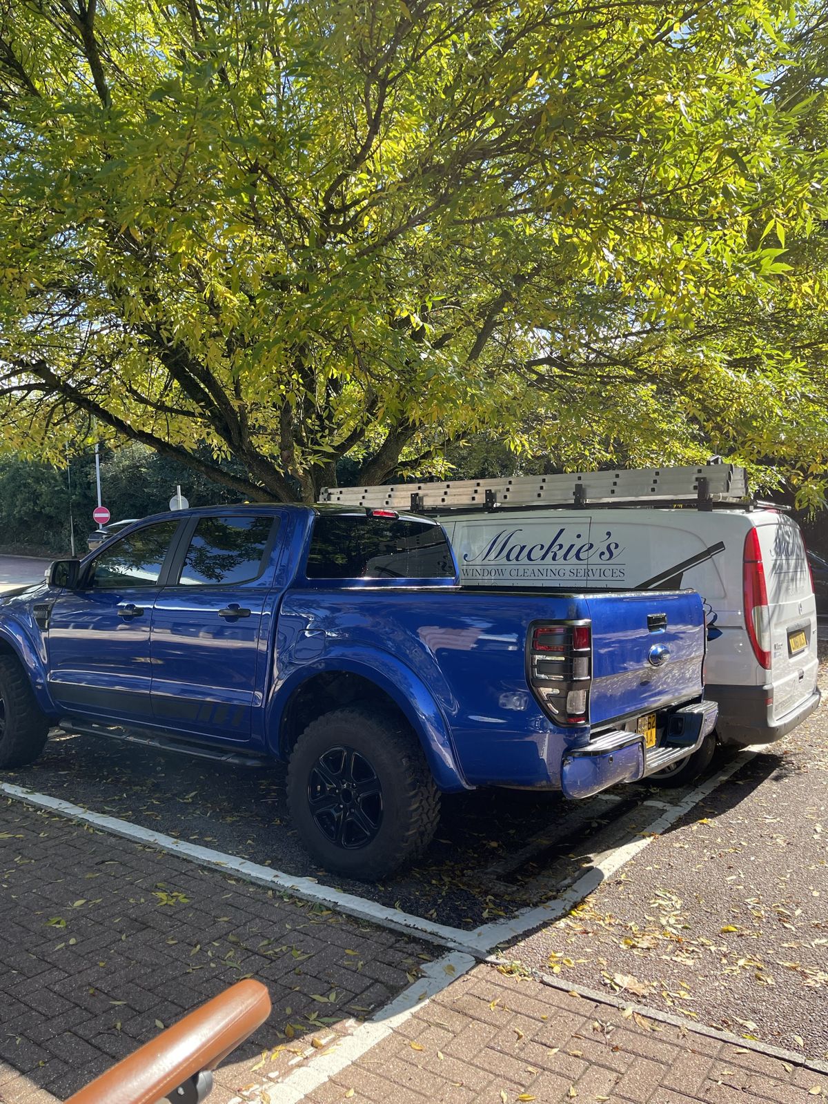 A pickup parked next to the old Mackie’s van outside a house